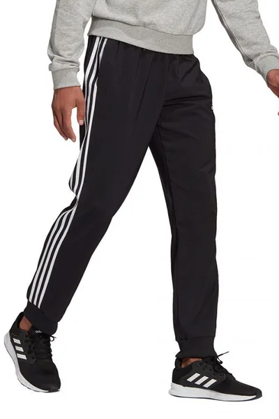 Sportovní kalhoty s pruhy a zúženými nohavicemi pro muže ADIDAS