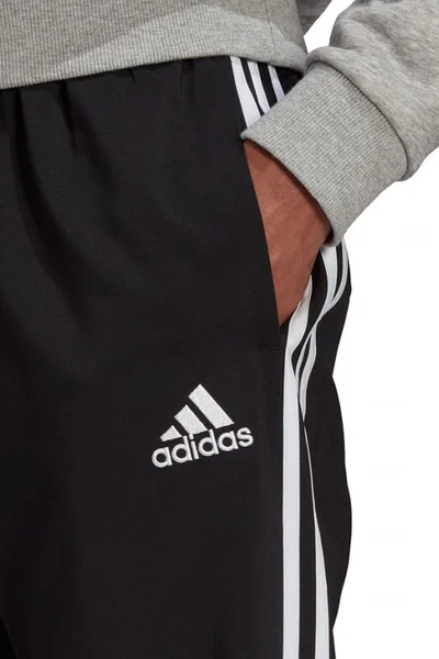 Sportovní kalhoty s pruhy a zúženými nohavicemi pro muže ADIDAS