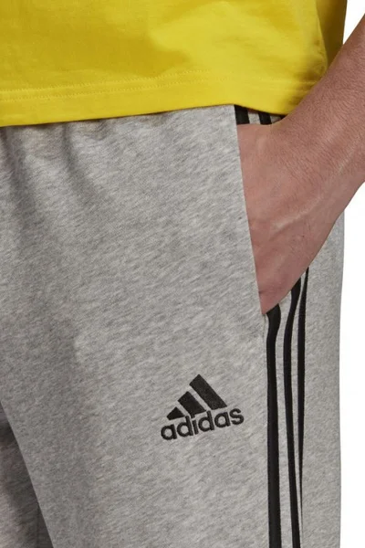 Pánské sportovní kalhoty s pruhy a zúženými nohavicemi ADIDAS